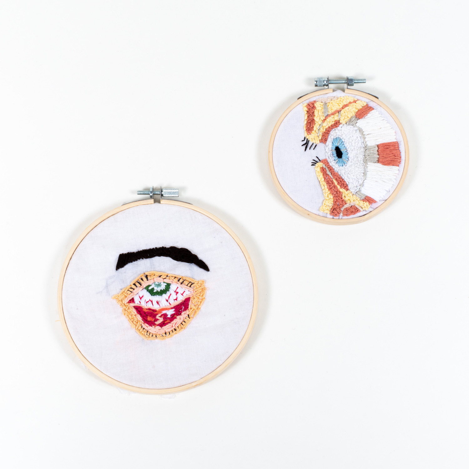 embroidery rings containing embroidered eyes