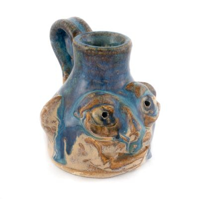 small face jug glazed in blue with handle and prominent ears.
