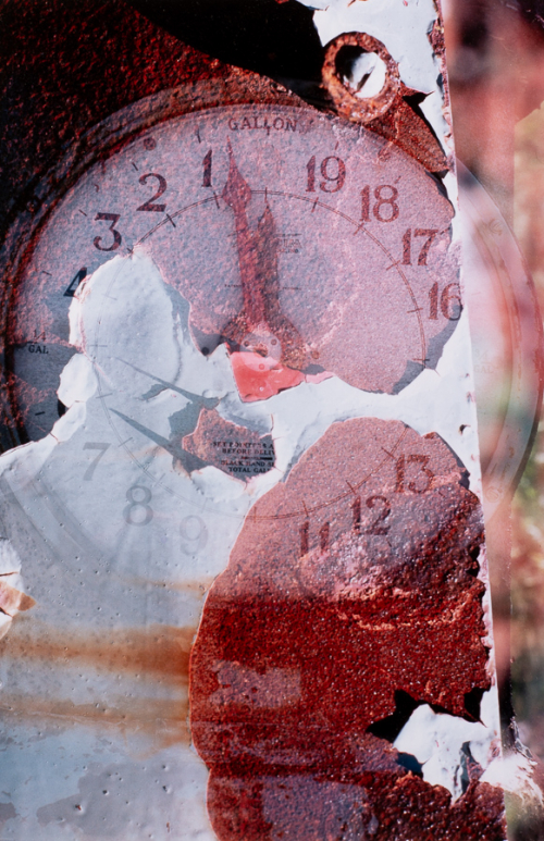 Clock written on inside of cover matt superimposed over peeling, rusty metal
