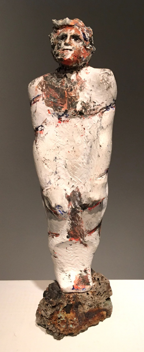 A tall male figure made of white plaster with red and blue markings