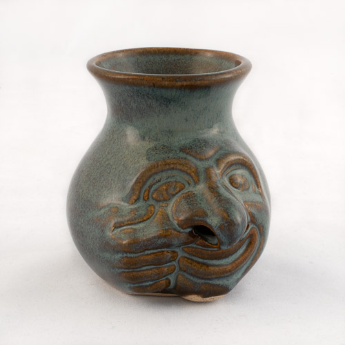 "face jug" with a blue glaze, right hand that pulls at the mouth and right nostril