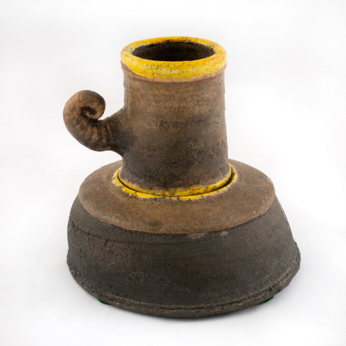 made of two parts, base is a brown upside down bowl, light at top with indented yellow circle where cup sits.