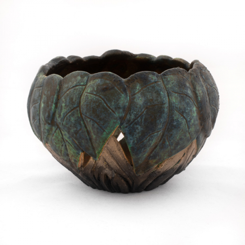 A small bowl with deep incisions, which break through the clay body, and represent plant leaves and stems. Decorated in matte gr