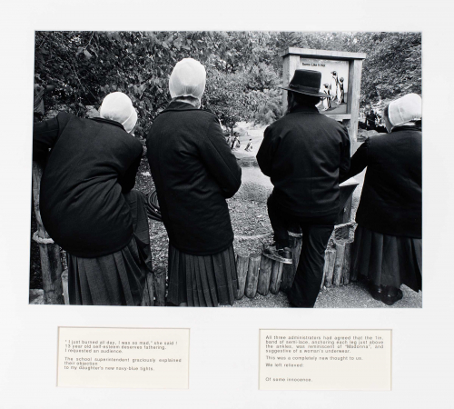 Rear view of three Amish females and one Amish male watching penguins at a zoo.