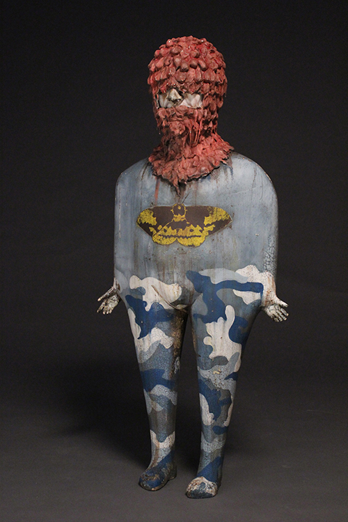 A figure with a red headdress and camouflage pants