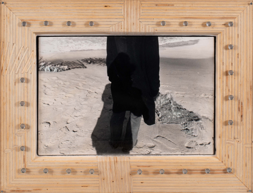 Image of person on a beach, beautiful wood frame with "inlaid" images picked up from photo: fence, shadows, footprint and head