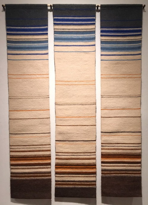 Left panel of a triptych. Horizontal bands of beige, brown, orange, blue, and gray. A wide gray band is topmost.