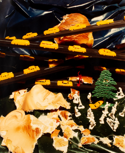 Photograph of bright yellow tiny cars and a toy car accident with a tree