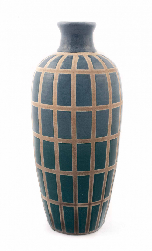 tall vase with a white-gray ground decorated with a grid of vertical rectangles. Glaze gradually goes from medium blue to teal