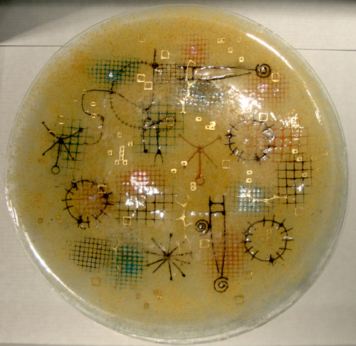 Light yellow glass bowl with various colors of grids, circles and small squares