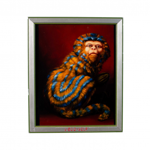 An image of a gold and blue striped monkey with face forward and body in profile. The frame has the words "1-800-SELF" in lower