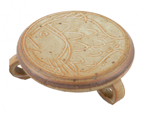 trivet with circular tripod legs and a stylized fish incised onto the top.