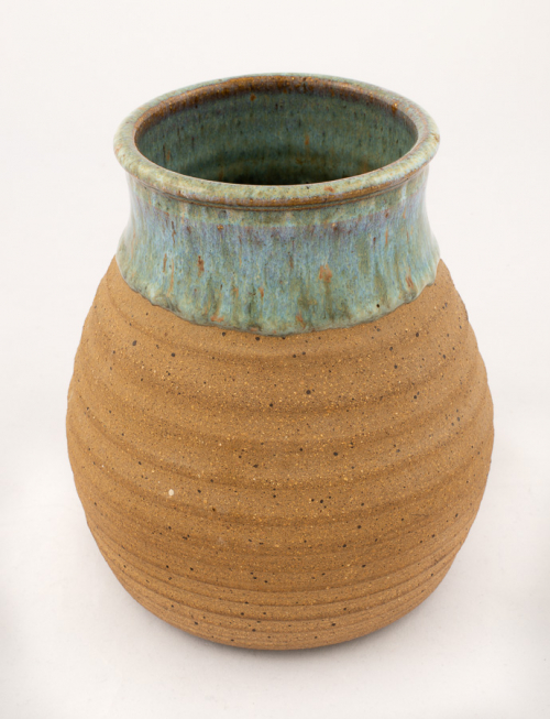 A pot, or jar, unglazed except for mottled light green on the neck, rim, and interior.