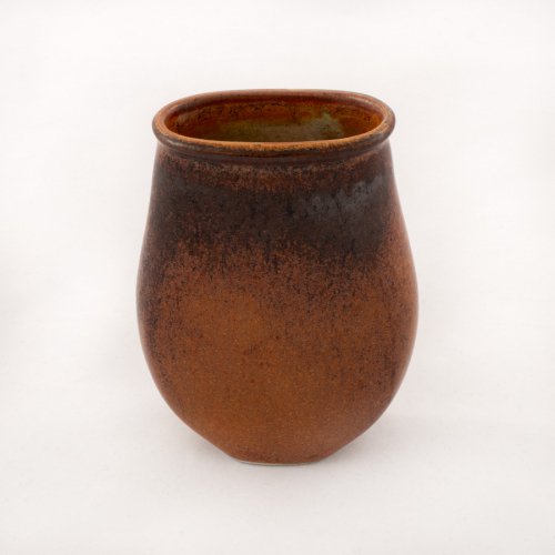 A vase form, flattened on two sides to make an ovoid, with a brown glazed exterior darkening near the top 