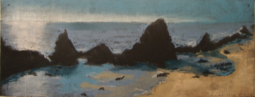 Dark rocks in silhouette on a shore