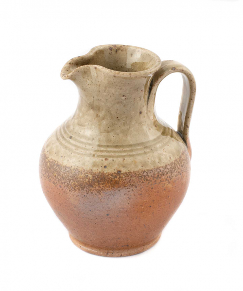  tiny pitcher with a wider mid-body than the upper section. Glazed greenish-beige at the top and reddish-brown at the bottom