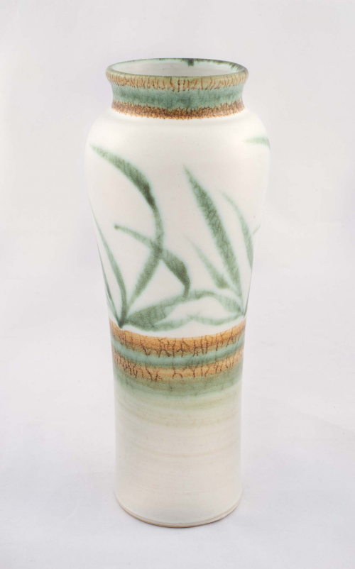 tall cylindrical vase that subtly curves, white with rings of brown and green at middle abstracted grass-like strokes