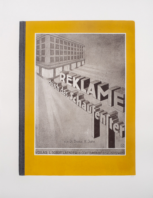 print of an antique book cover with words angled forward from a building-like structure in background and gold border
