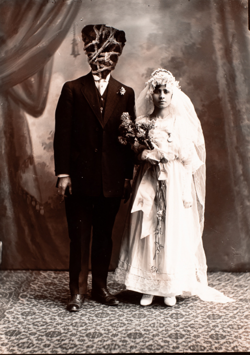 antique styled image of a couple in formal wedding attire. The male figure's head is a triangular stone wrapped in string