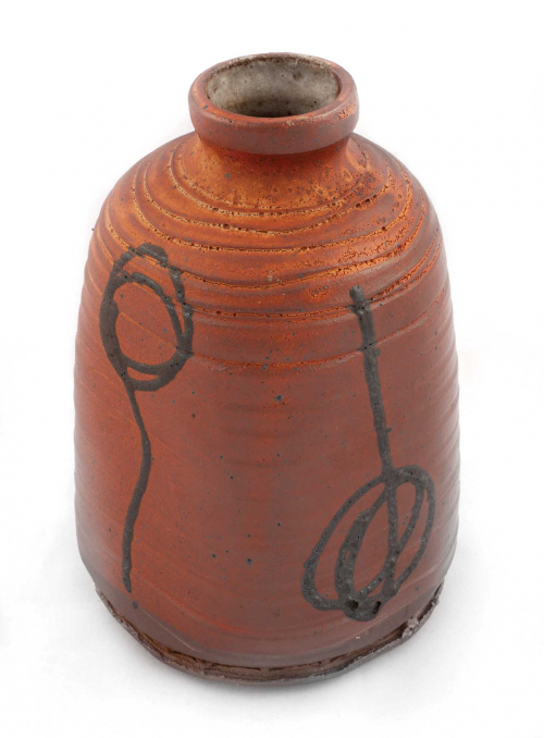 rounded vase, squared off with narrow neck, and black curvilinear designs on all four sides glazed in an orange-brown