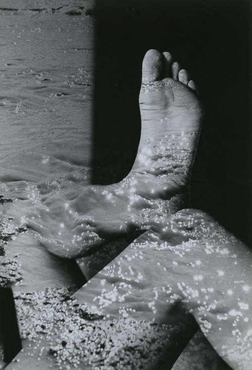 Appears to be shadows of water cast onto a person's legs and foot