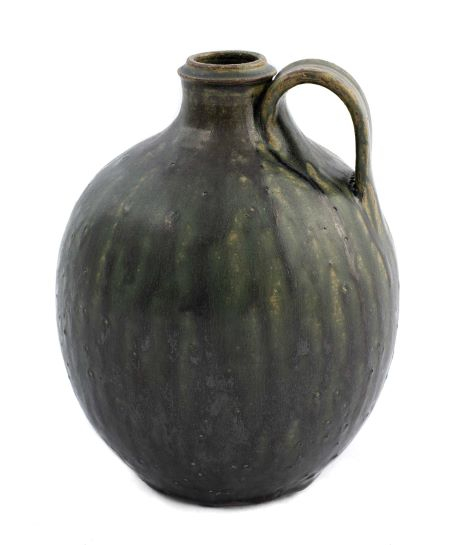 jug with single handle glazed in dark greens with subtle bubbles and dripping down the sides