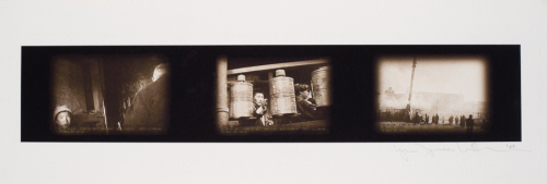 A narrow, horizontal sepia-toned print with three images side by side. The center image features Buddhist prayer wheels.