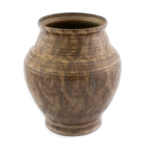 An ovoid-shaped vase, which is subtly ridged with swirls of a brown and tan colored glaze