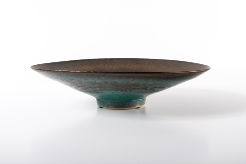 Side view of medium sized shallow bowl or platter with a brown and blue/green glaze