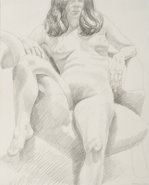 Seated female model with leg over chair arm.