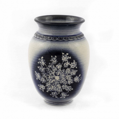  small white egg-shaped bud vase with a cobalt blue rim, a ring at the shoulder, and a single image of Queen Anne's Lace 