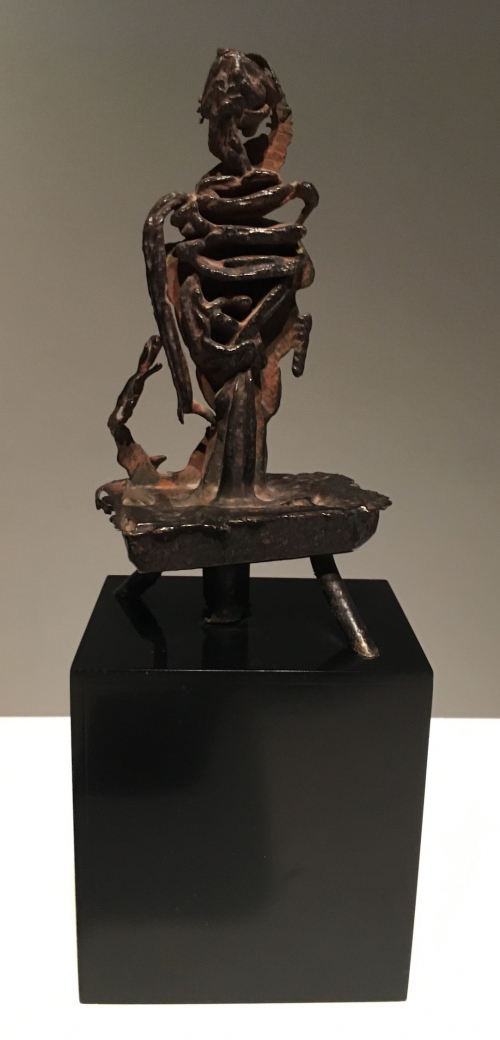 Figurative sculpture with square base and tripod of legs