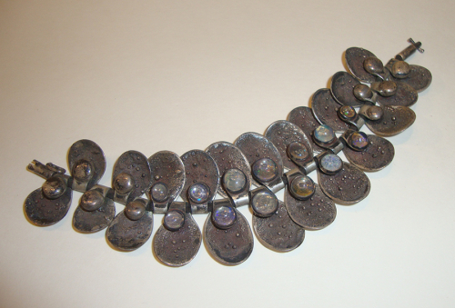 Silver bracelet with large "clam-shaped" petals and circular opals