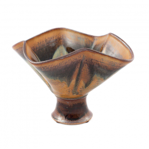 wide wavy rimmed bowl with a small base. Glazing decoration is brown, beige, blue-green
