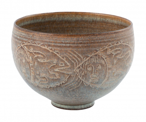 Brown and gray bowl with decorative patterns and faces on the sides
