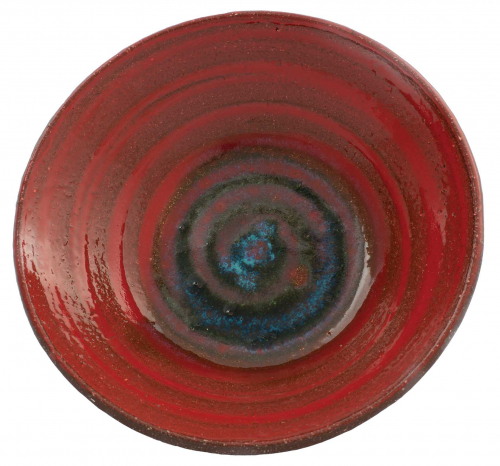 small, shallow bowl with interior spiral markings, red on the sides and deep blue at the center.