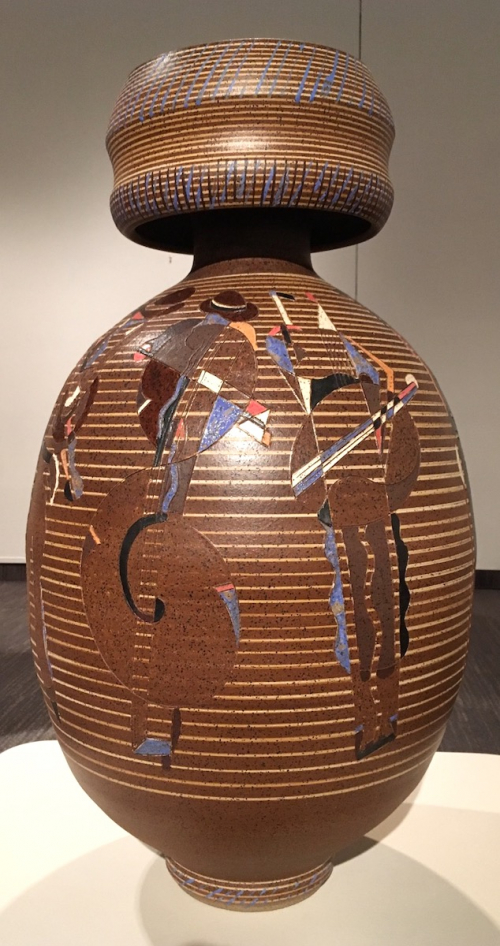 A large ovoid vase with cylindrical cap, glazed in brown with abstract markiings