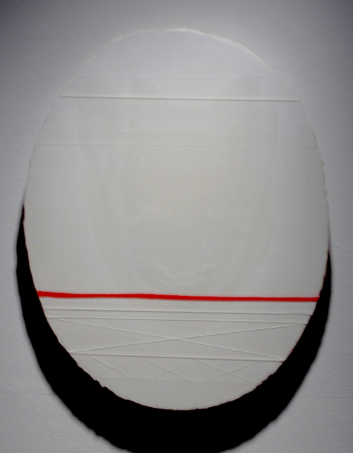 An oval-shaped canvas painted in whites with a lightly drawn image of a wolf or coyote fave and a bright red line