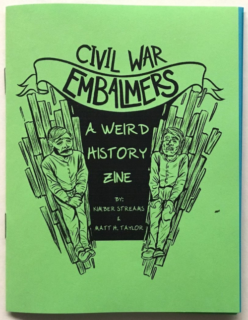 A zine printed with black ink on bright green and blue paper. Author: Kimber Streams; Artist: Matt H. Taylor.