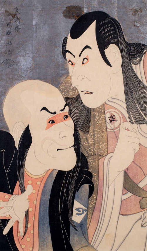 Upclose faces of two kabuki actors; an older man with long hair falling over his shoulders and clenched fist
