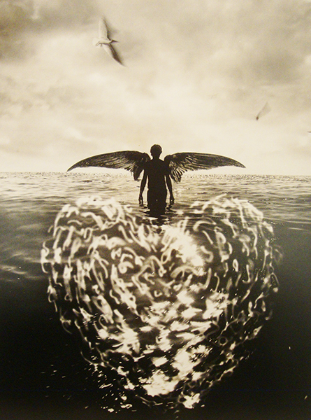A winged figure walking in the water toward the horizon