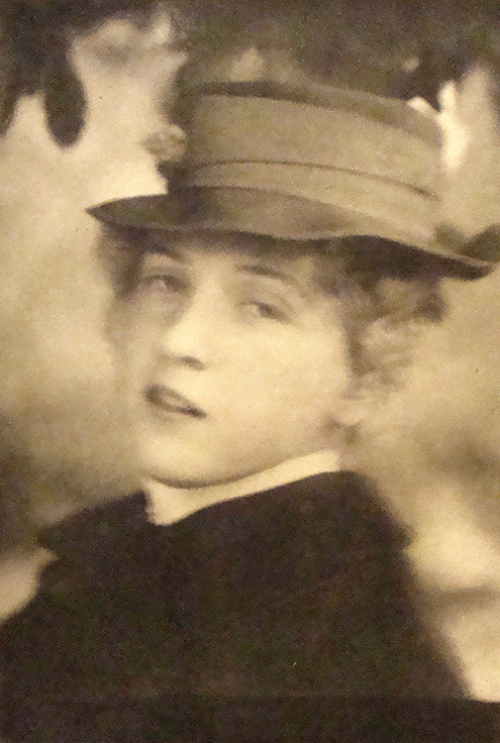 Head a bust of a young female wearing a hat