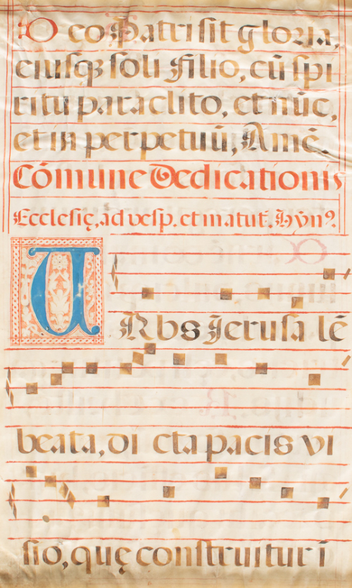 Gregorian chant page with black, blue, and red notation