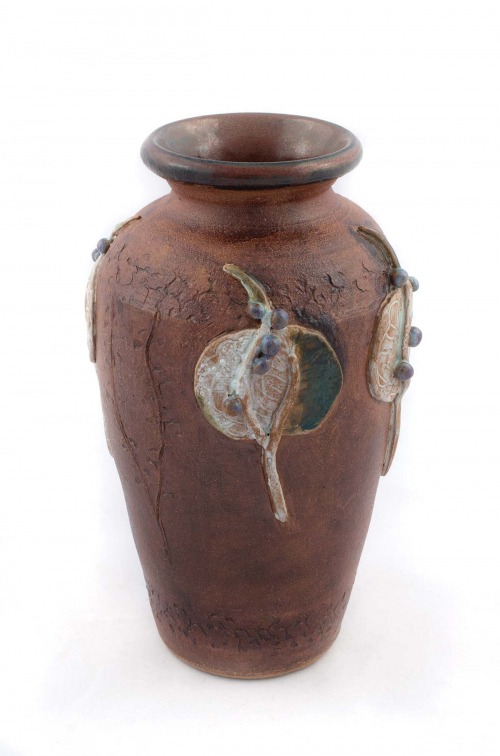 vase form glazed in a matte brown with applied plant-forms in white and green