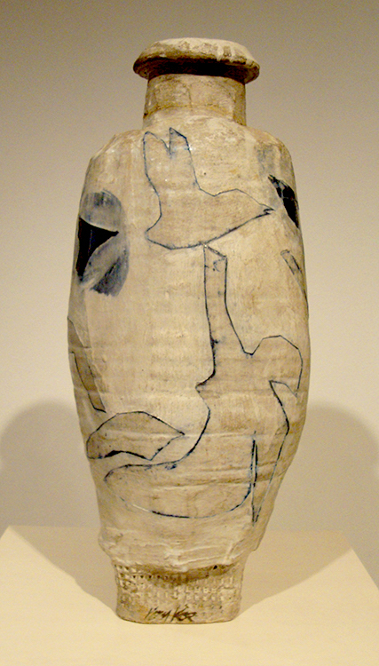 A large irregularly shaped white vase-form with blue figures and animals in blue