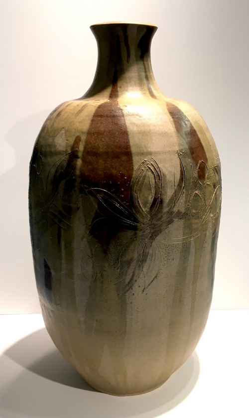 A large beige ovoid vase form with a narrow neck. 