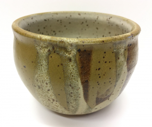 A rice bowl form, beige with dark brown speckles inside and mid-brown with dark brown speckles outside.
