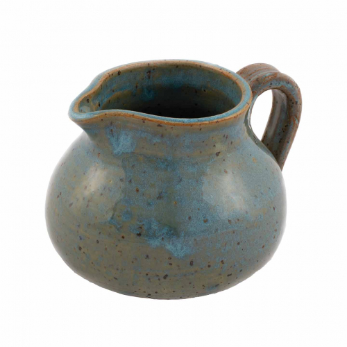 squat pitcher with handle glazed in mottled blues and greens