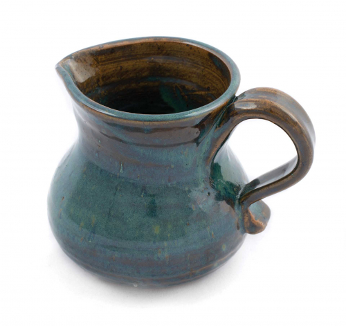 squat pitcher with handle glazed in dark brown and deep turquoise.
