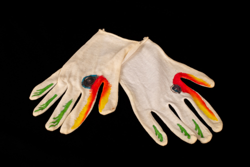 2 right-handed white cotton gloves painted with red, yellow, green, blue, black marks and shapes to resemble bird-like puppets